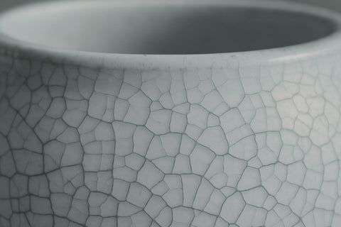 close-up of the rim of a pottery piece with visible crackle glaze texture